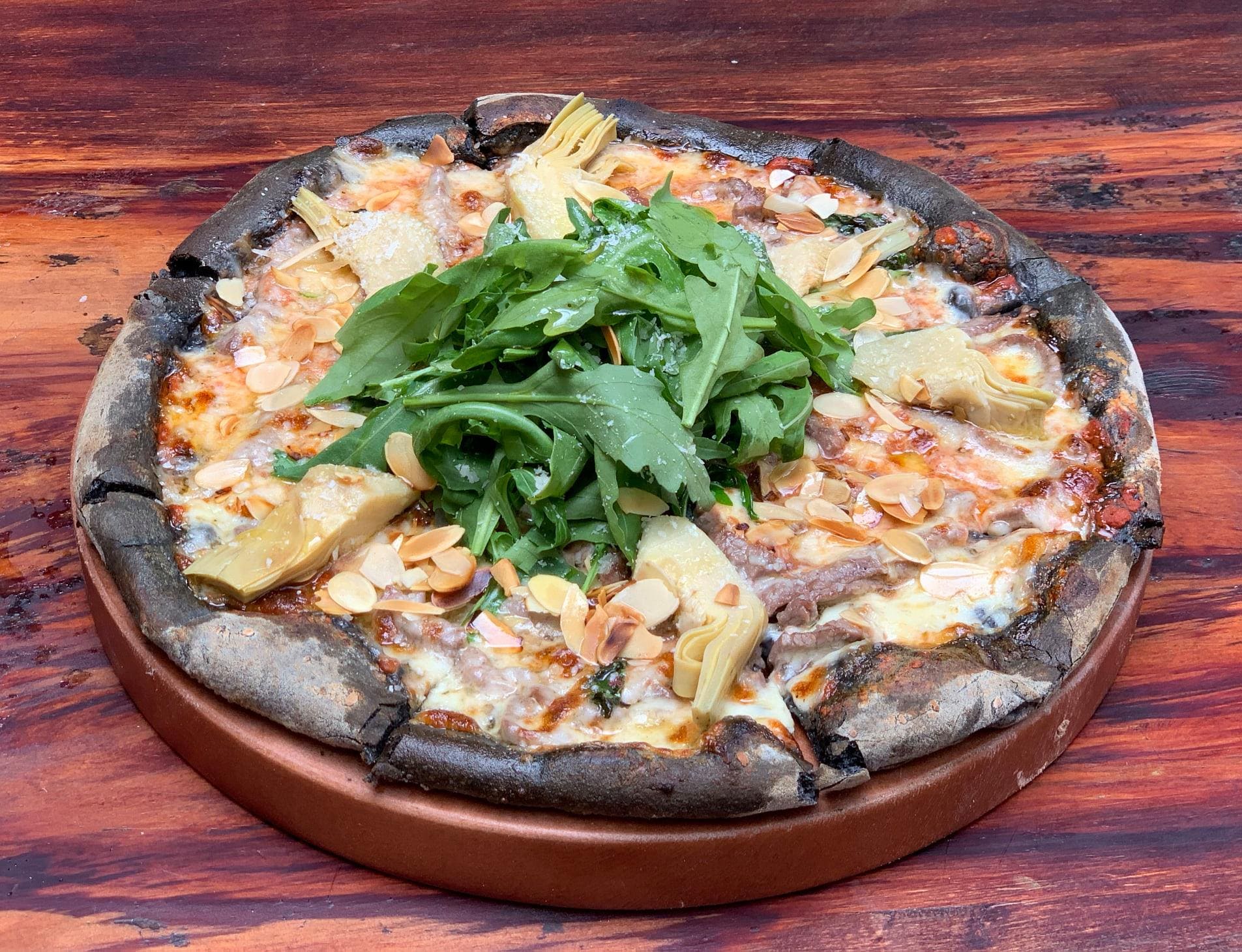 The pizzas are handmade with lightly crisped crusts and fresh